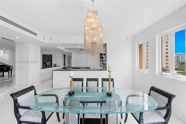 a living room with furniture a table and chairs