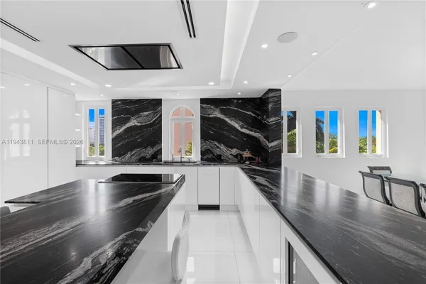 a kitchen with stainless steel appliances granite countertop a sink and a stove