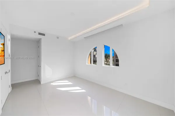a bathroom with a shower and a glass door