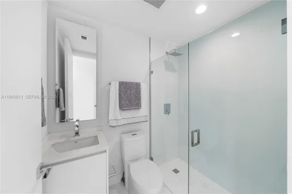 a bathroom with a sink vanity and a mirror