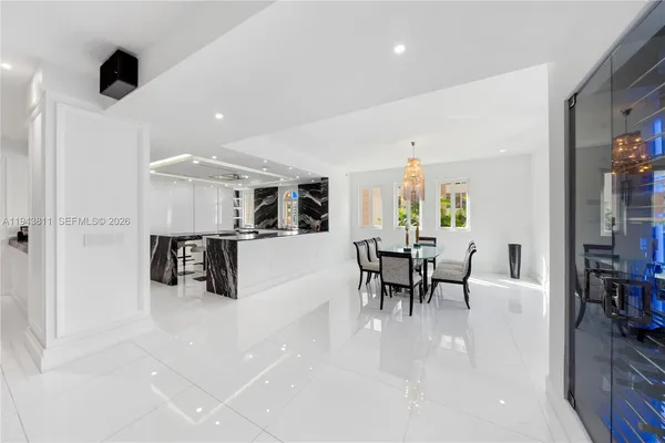 a dining room with furniture and a kitchen view