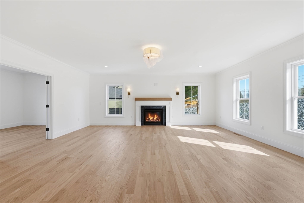 16 Couture Way Middleton, MA 01949 - Photo 11 of 36 an empty room with windows and fireplace