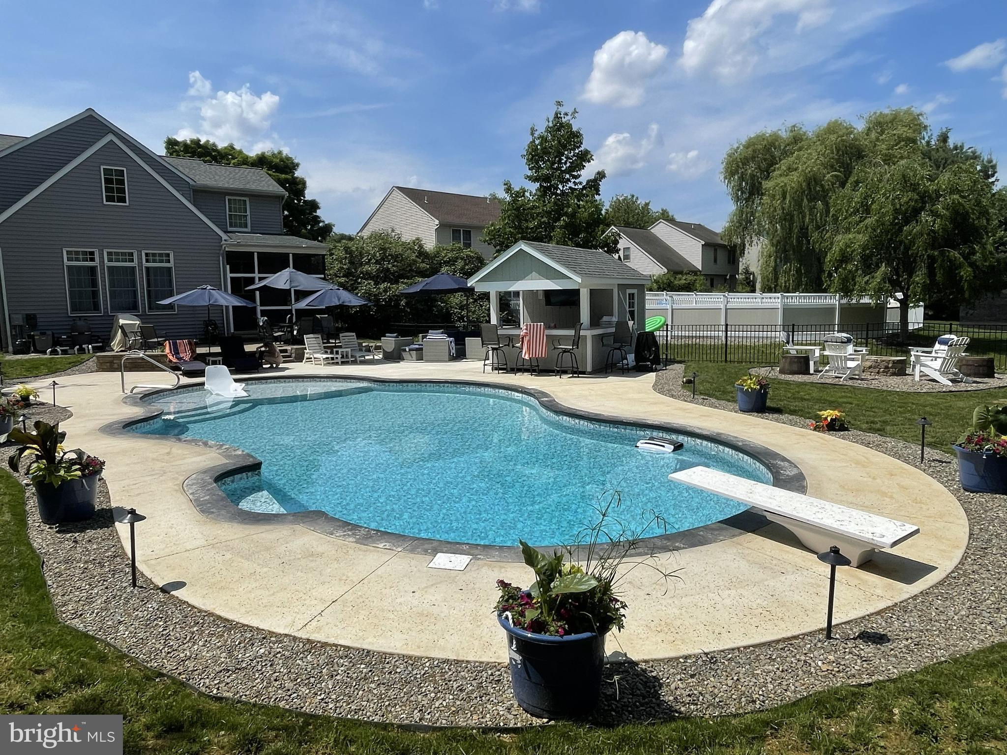 a view of a house with swimming pool and sitting area
