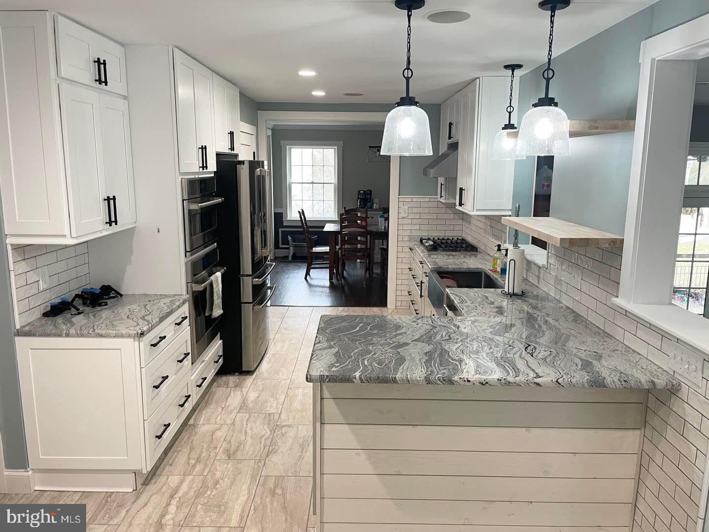 119 Saybrooke Drive Lititz, PA 17543 - Photo 13 of 40 a large kitchen with kitchen island a large counter top space a sink stainless steel appliances and cabinets