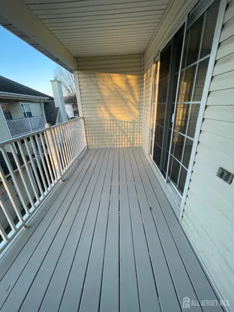 a view of balcony with wooden floor