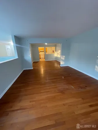 a view of a room with window and wooden floor