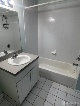 a bathroom with a sink vanity and a bathtub