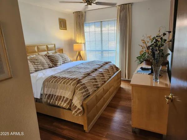 a bedroom with bed and a potted plant