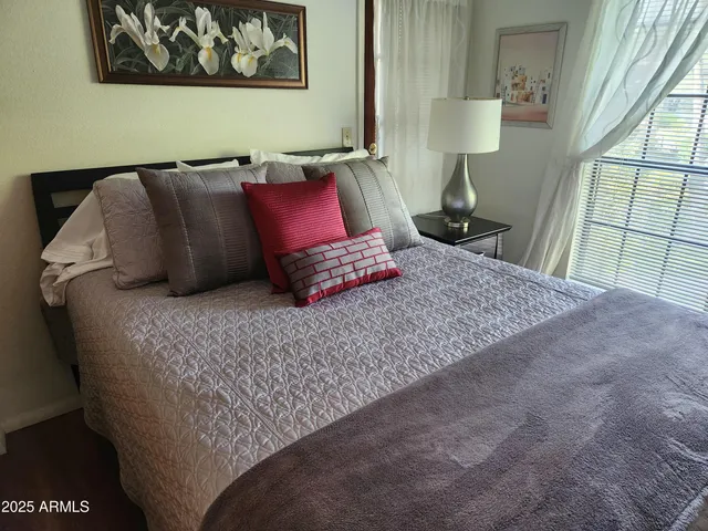 a bedroom with a bed and a window