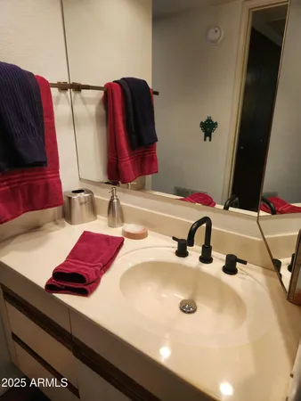 a bathroom with a granite countertop tub and a sink