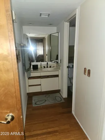 a bathroom with a sink mirror vanity and toilet