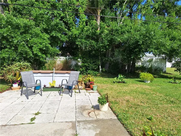a view of backyard with a patio