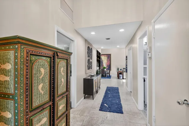 a view of a dining room with furniture and a potted plant