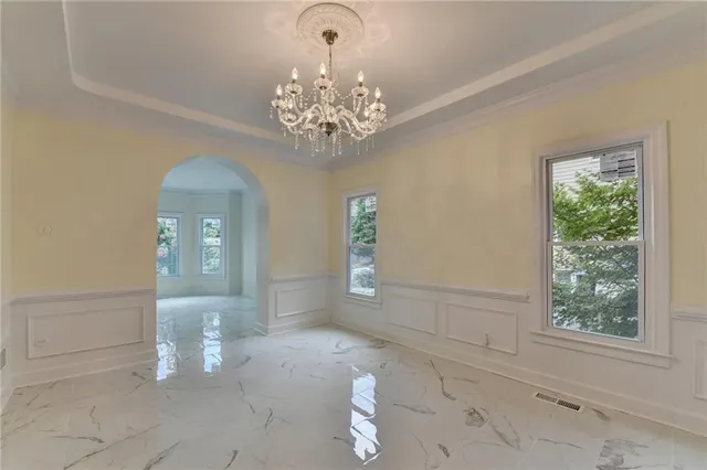 a view of a livingroom with furniture a ceiling fan and window