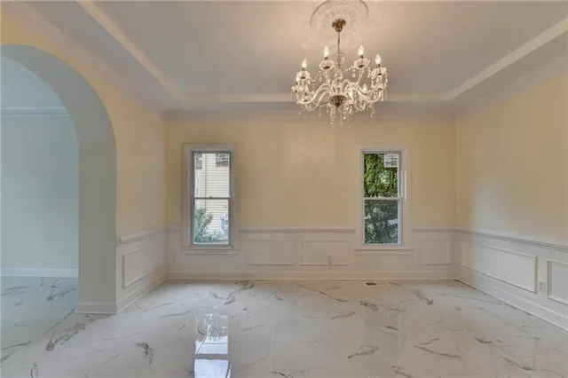 a view of a livingroom with wooden floor and staircase