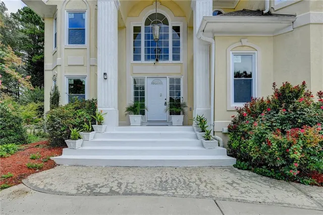 a view of an empty room with a chandelier
