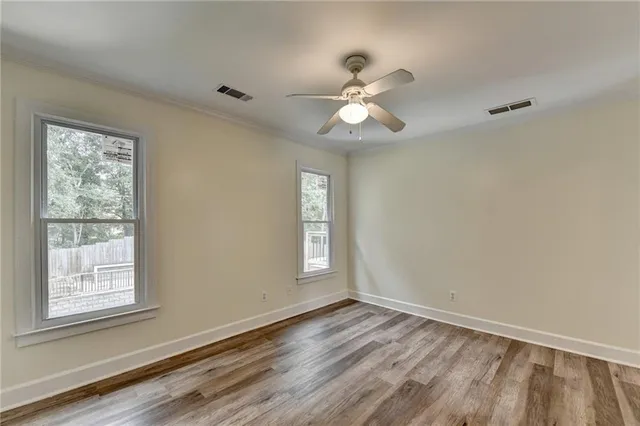 a view of a backyard with wooden floor and floor to ceiling window
