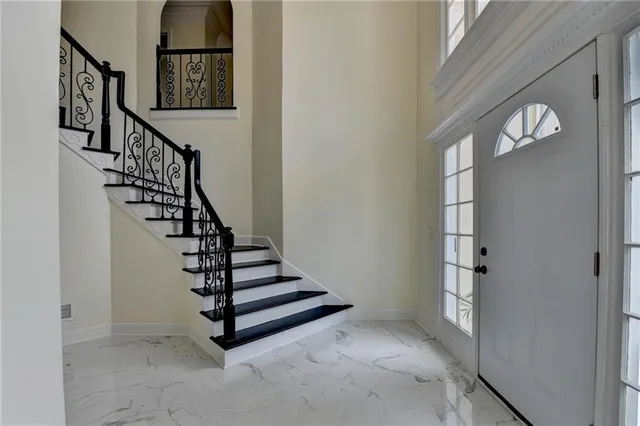 a view of a livingroom with a chandelier windows and cabinet