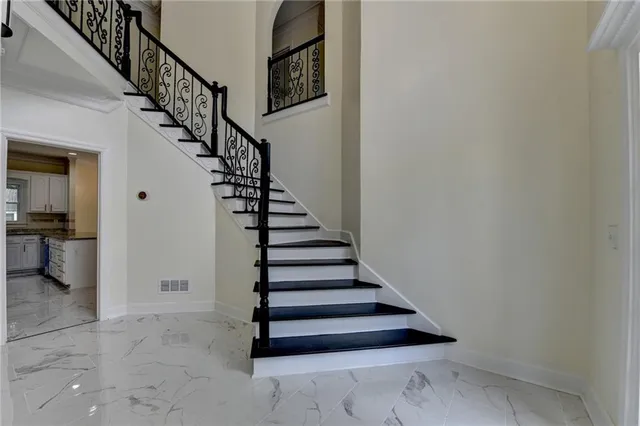 a view of a hallway with windows and chandelier