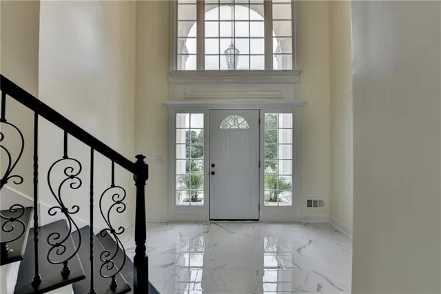 a kitchen with stainless steel appliances granite countertop a refrigerator and a stove