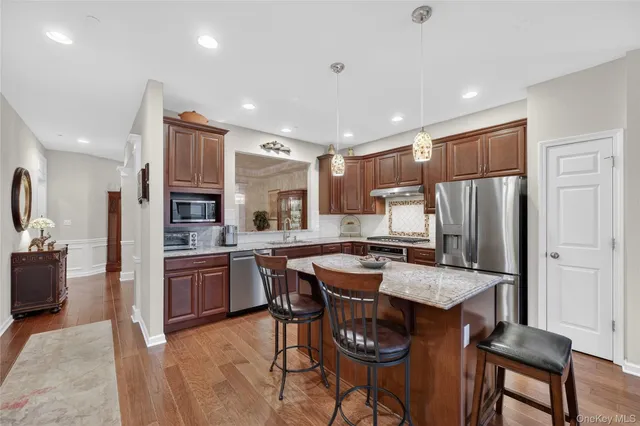 a kitchen with granite countertop a stove and cabinets