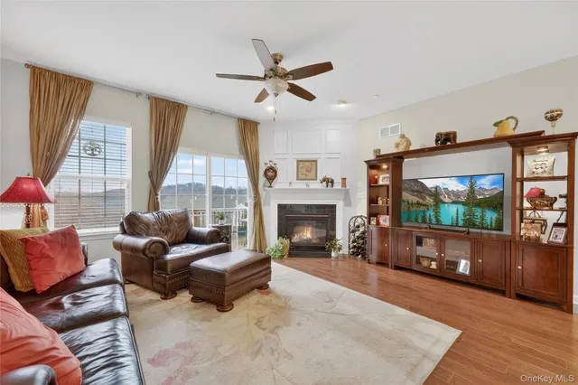 a living room with furniture a window and a fireplace