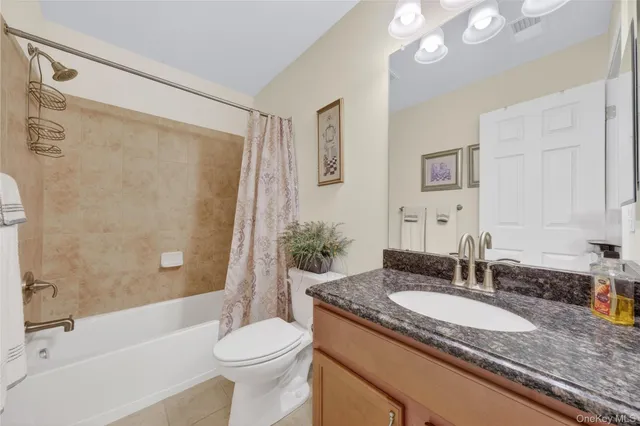 a living room with furniture and a lamp