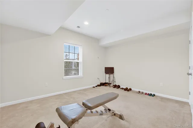 a living room with furniture a flat screen tv and a large window