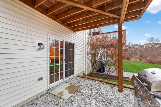 a view of an empty room with window and chandelier