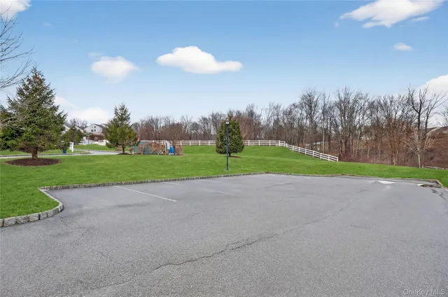 a view of a house with a yard and sitting area