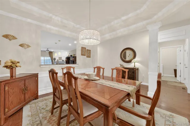 a view of a dining room and a kitchen with a table chairs