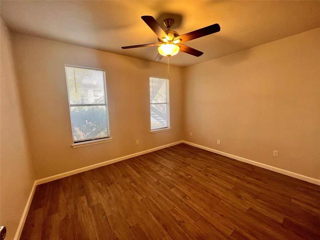 2008 West Loop, Unit B Austin, TX 78758 - Photo 11 of 11 Spare room featuring dark wood-type flooring and a ceiling fan