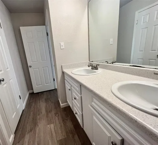 a bathroom with a double vanity sink and a mirror