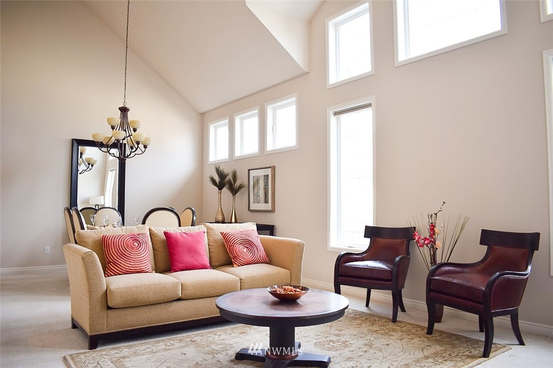 1217 South 36th Place Renton, WA 98055 - Photo 6 of 15 a living room with furniture a rug and a window