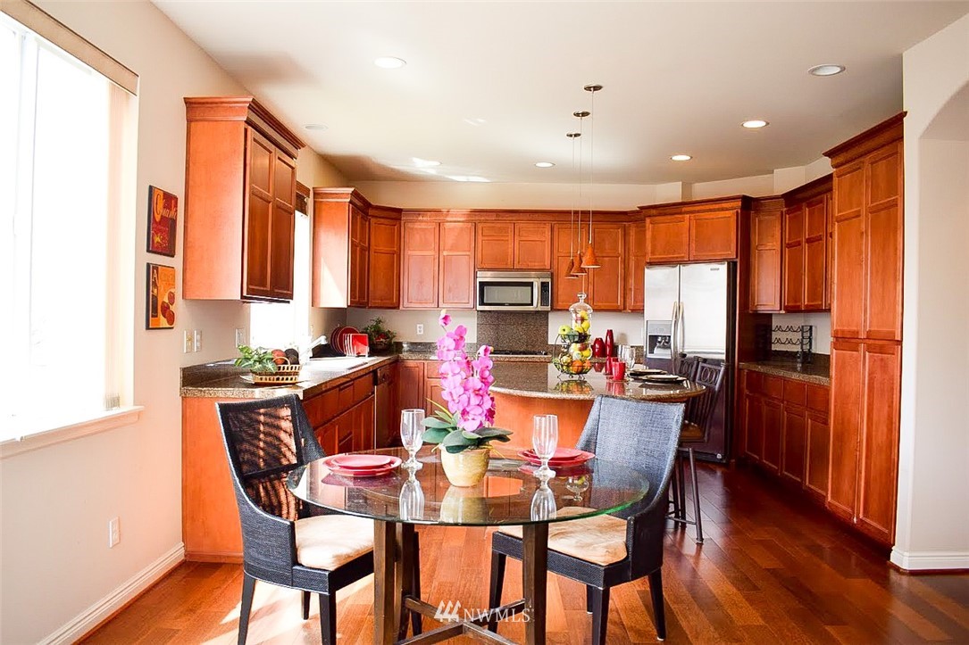 1217 South 36th Place Renton, WA 98055 - Photo 8 of 15 a view of a dining room with furniture window and wooden floor