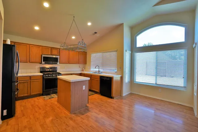 a kitchen with stainless steel appliances a refrigerator and a stove