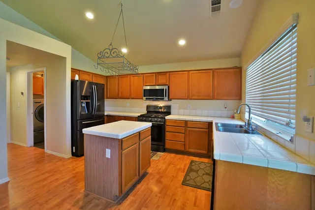 a kitchen with stainless steel appliances granite countertop a sink and a cabinets