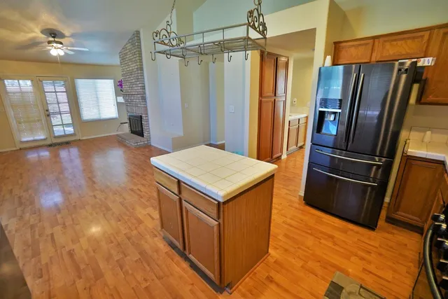 a kitchen with granite countertop cabinets stainless steel appliances and wooden cabinets