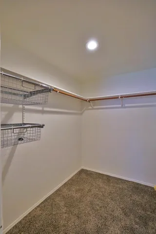 an empty room with a ceiling fan and window