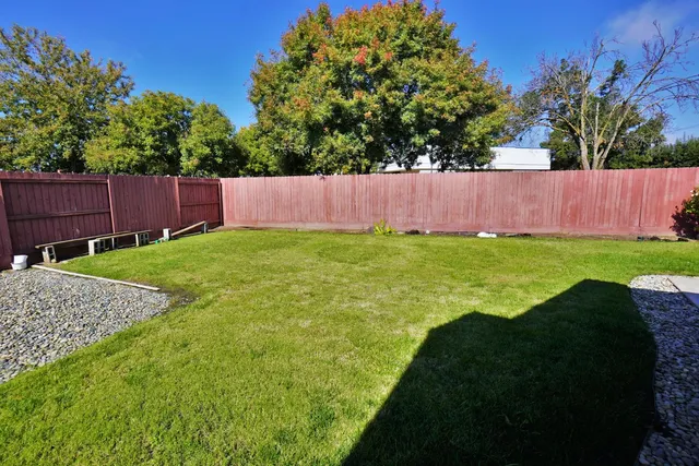 a front view of a house with yard and green space