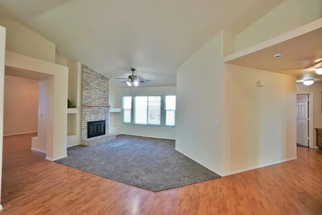 a view of livingroom with hardwood floor and kitchen view