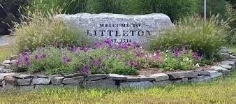 a sign that is sitting in the water next to a building