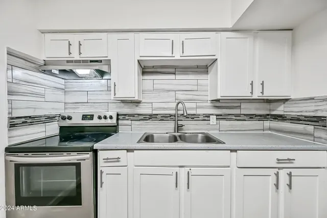 a kitchen with cabinets a sink and appliances