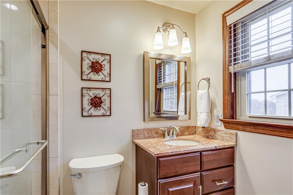 201 Calvin Drive McKees Rocks, PA 15136 - Photo 15 of 22 The updated master bath includes a granite vanity and a tiled walk-in shower.