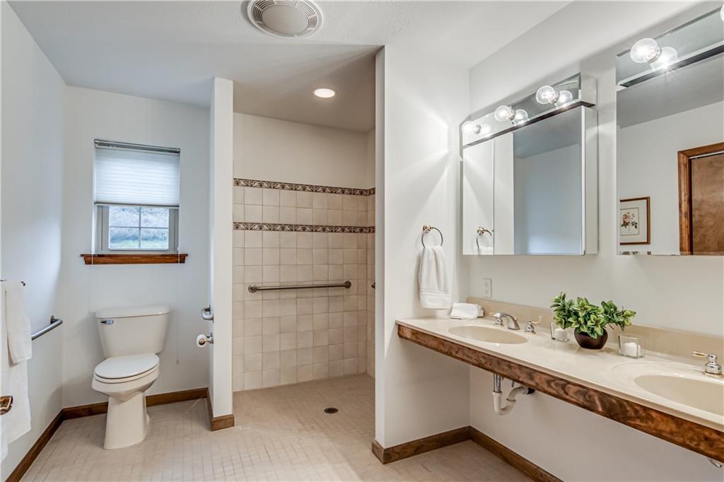 201 Calvin Drive McKees Rocks, PA 15136 - Photo 10 of 22 The first floor suite offers a full bath with tiled walk-in shower and double sink vanity.
