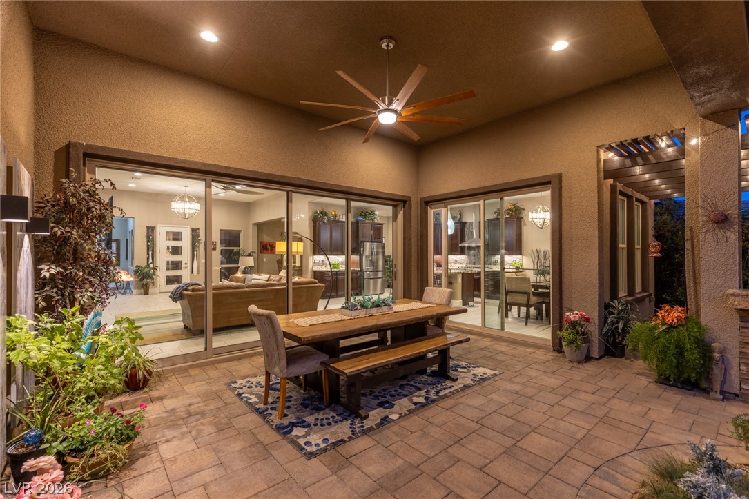 10167 Copper Edge Road Las Vegas, NV 89148 - Photo 38 of 45 A spacious, paved patio extends entertaining to the outdoors, offering seamless transitions through large glass sliding doors.