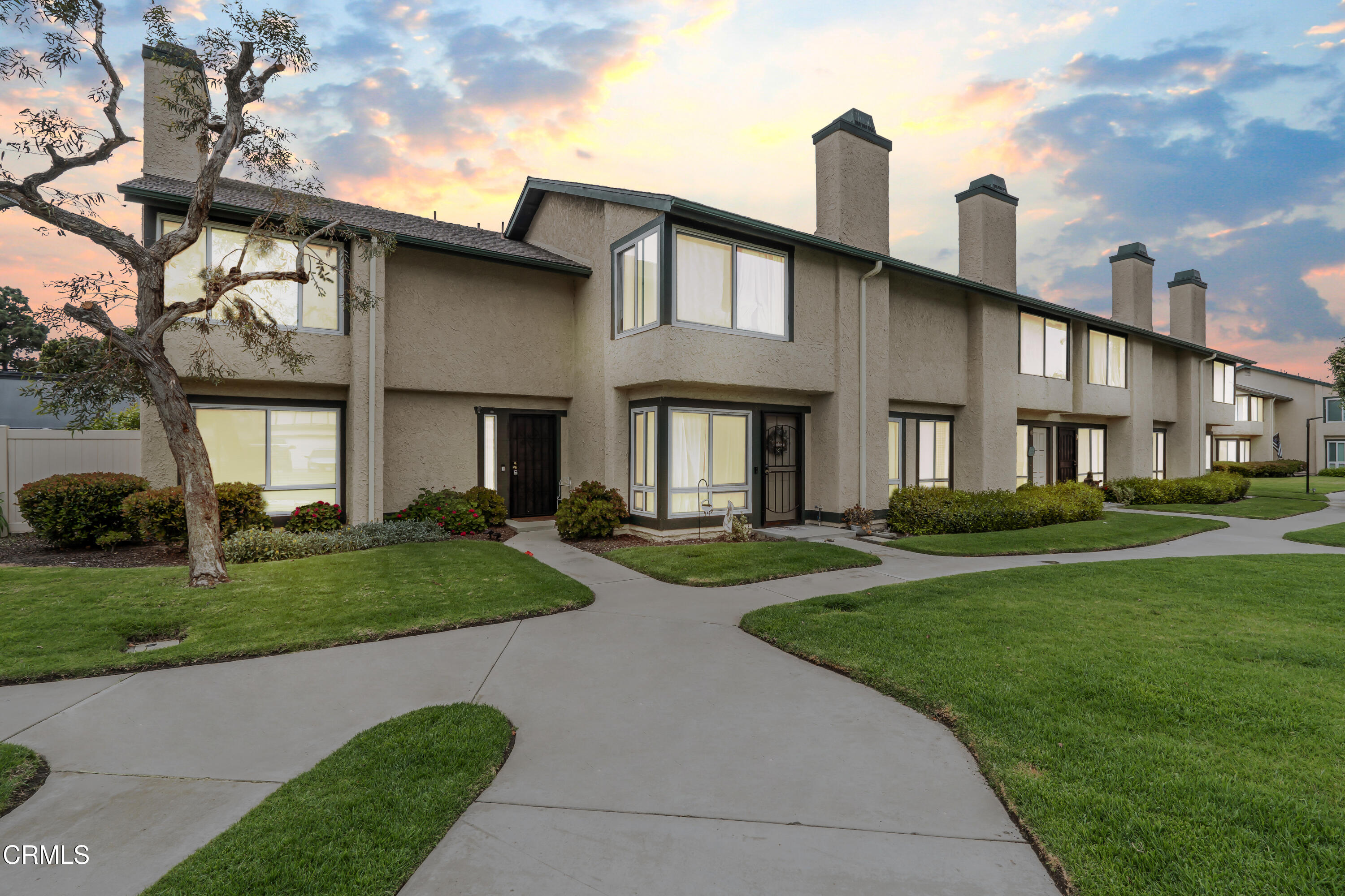 a front view of a house with a yard table and chairs