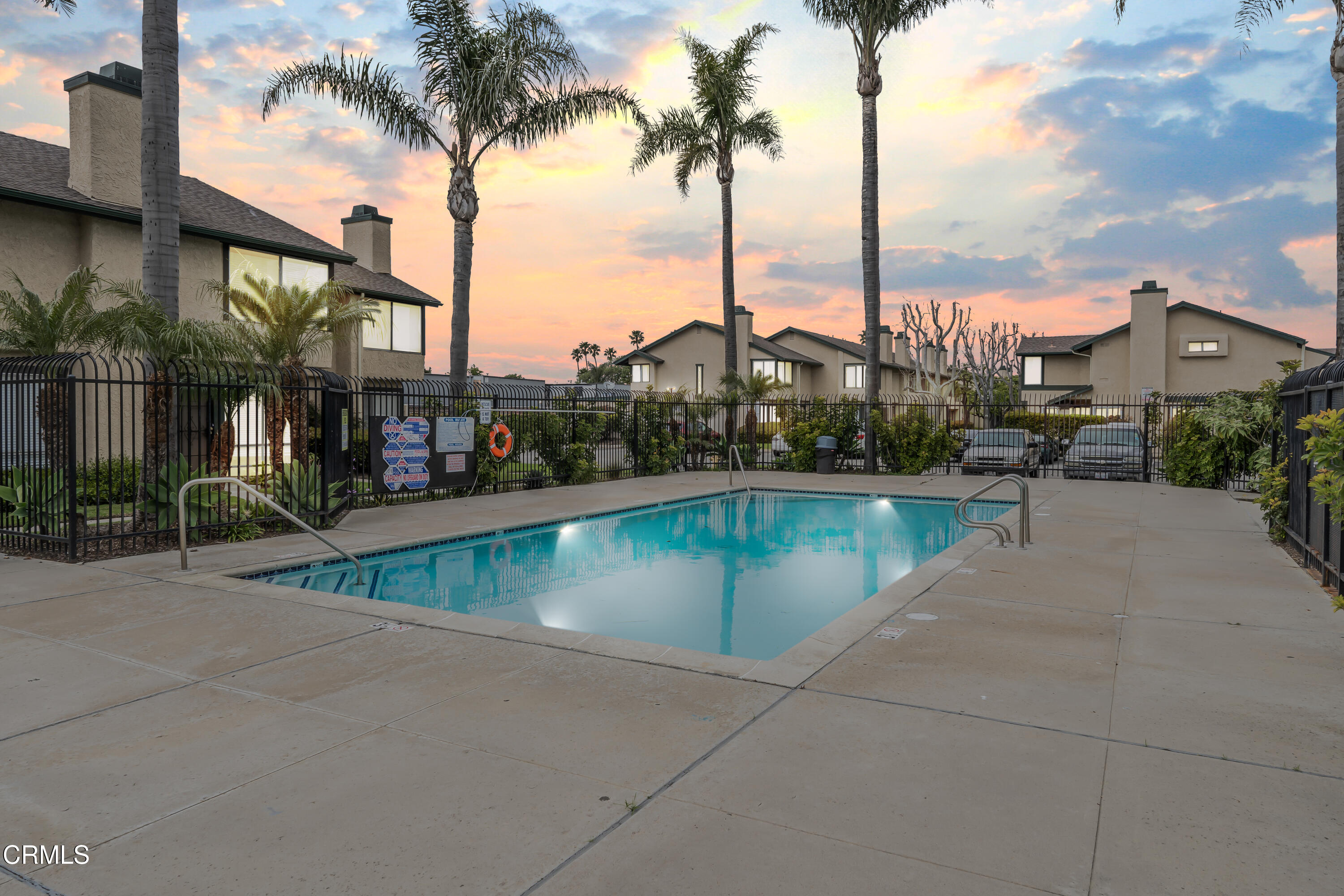 5289 Perkins Road Oxnard, CA 93033 - Photo 21 of 23 a view of a swimming pool with a yard and palm trees
