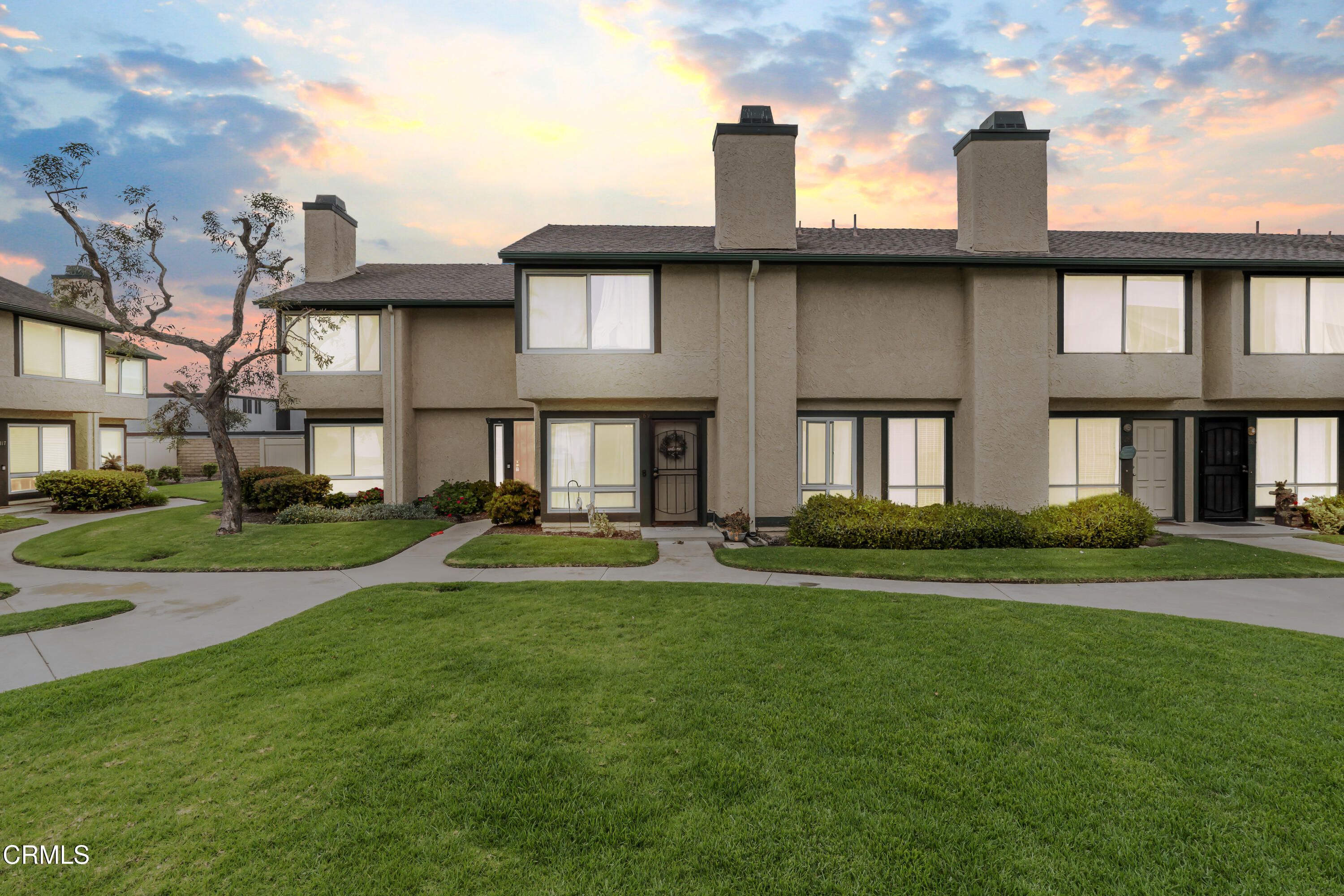 5289 Perkins Road Oxnard, CA 93033 - Photo 23 of 23 a front view of a brick house with a yard table and chairs