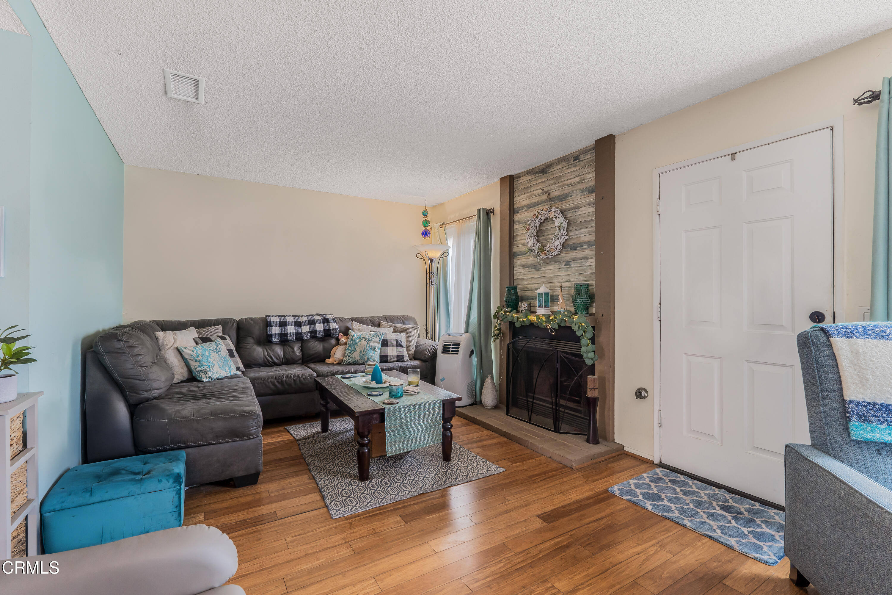 5289 Perkins Road Oxnard, CA 93033 - Photo 3 of 23 a living room with furniture and a flat screen tv
